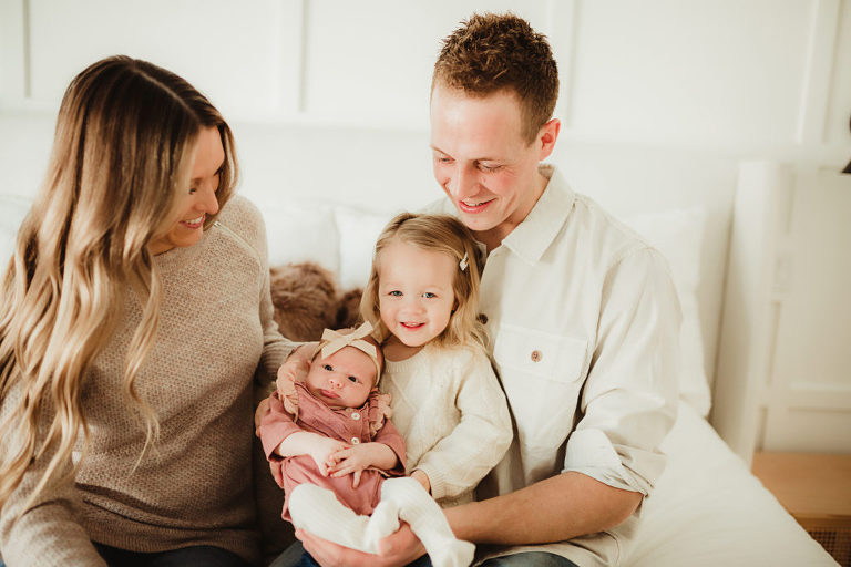 In home lifestyle session with newborn looking right at the camera